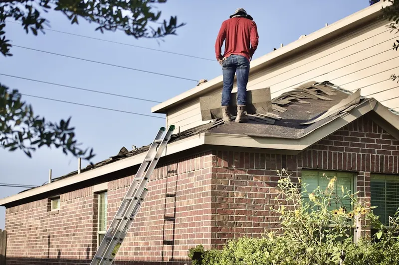 Professional roofer working on a residential roof in North Abington